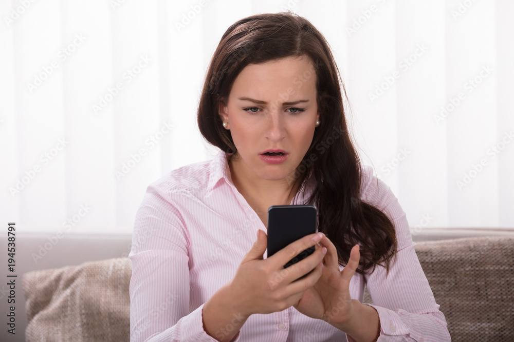 Shocked Woman Looking At Mobile Phone Shocked Woman Looking At Mobile Phone