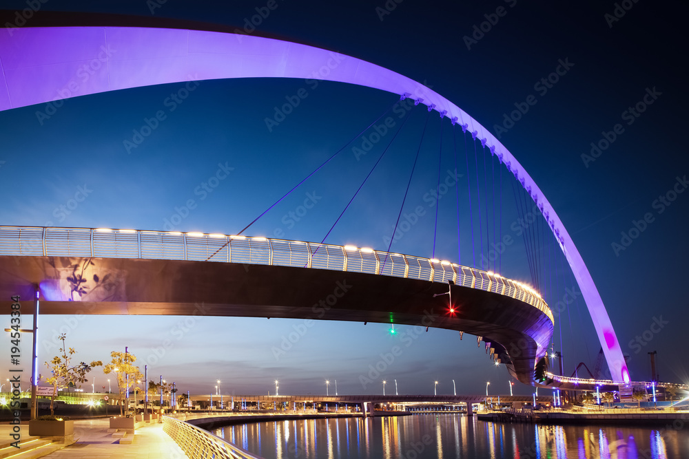 Fototapeta premium DUBAI, UAE - FEBRUARY, 2018: Dubai Water Canal arch bridge or Tolerance bridge