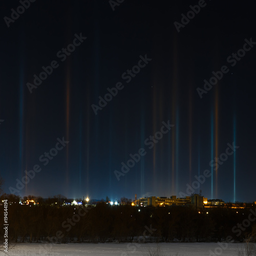 Multicolored radiance in the atmosphere. A natural phenomenon in the night sky over the city.
