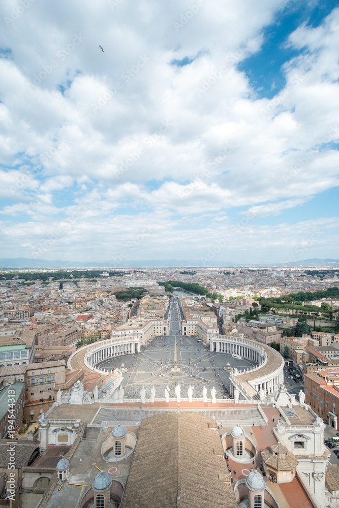 Saint Peter's Square, the large plaza in front of St. Peter's Basilica in Vatican City with the aerial view of Rome, Italy.