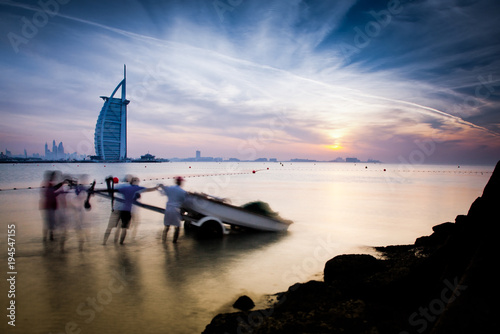 Photography DUBAI, UAE - FEBRUARY 2018 :The world's first seven stars luxury hotel Burj Al Arab at sunset seen from Jumeirah public beach in Dubai, United Arab Emirates