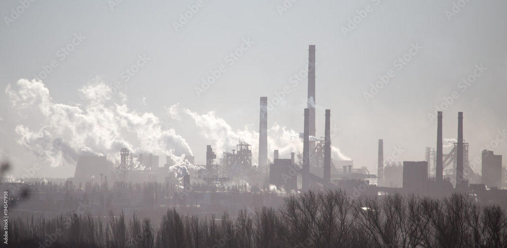 Smoke from the pipes of an industrial plant in the morning