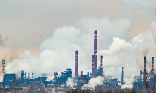 Smoke from the pipes of an industrial plant in the morning