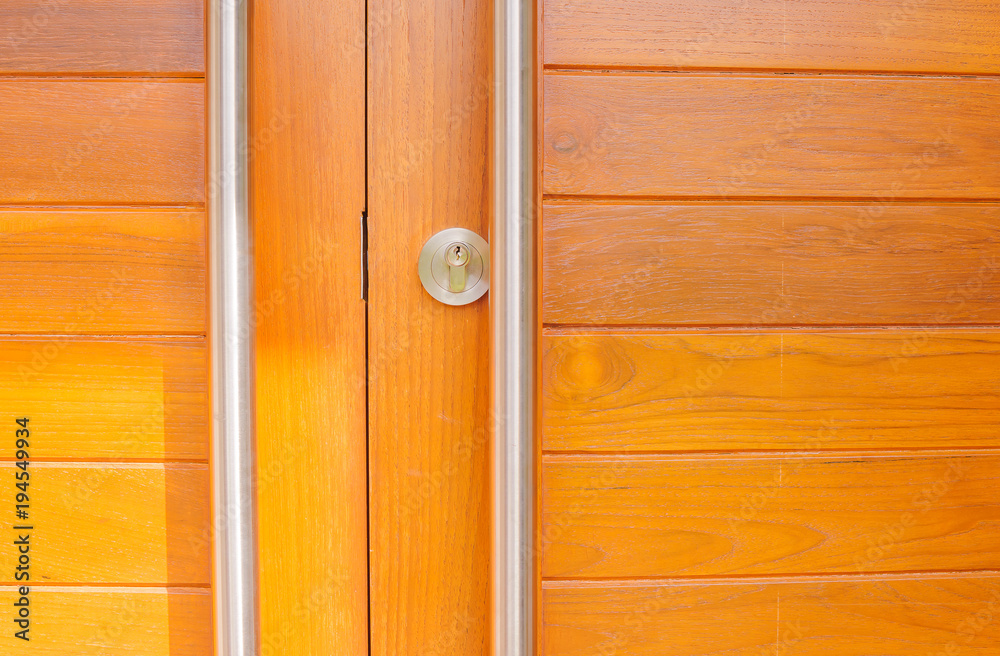 Fototapeta premium Modern wooden doors and door handles are made of stainless steel with sunshine in the morning. Vintage Style
