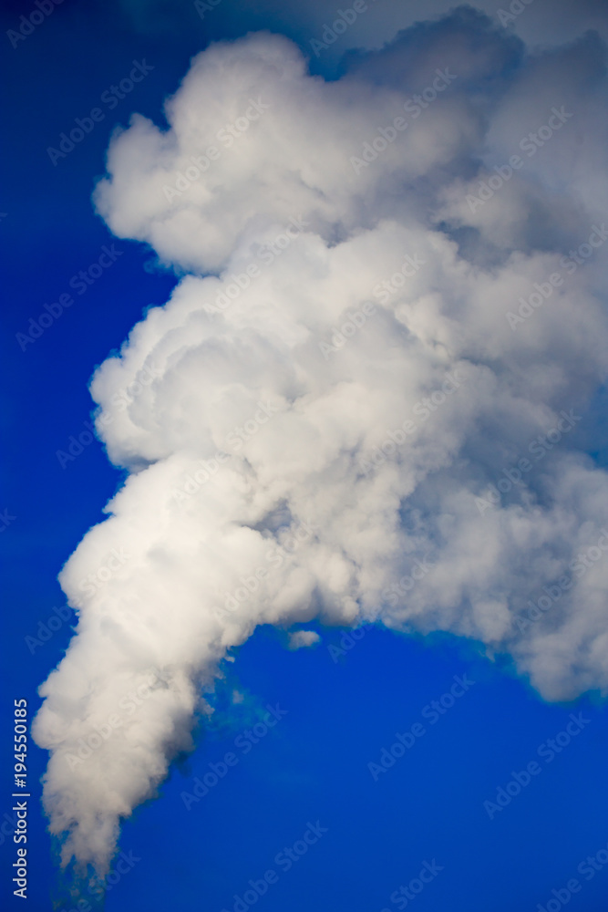 smoke from a pipe in the factory against a blue sky smoke from a pipe in the factory against a blue sky