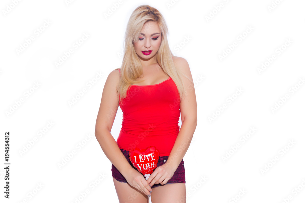 Portrait of a beautiful sexy blonde woman with a balloon in the shape of a heart. The red ball says Portrait of a beautiful sexy blonde woman with a balloon in the shape of a heart. The red ball says