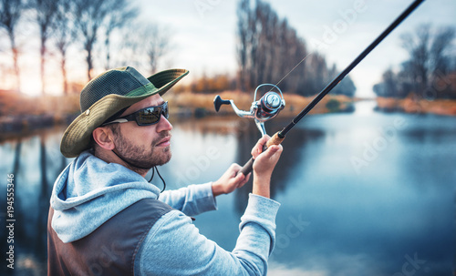 Fisherman enjoys in fishing on the river. Sport, recreation, lifestyle