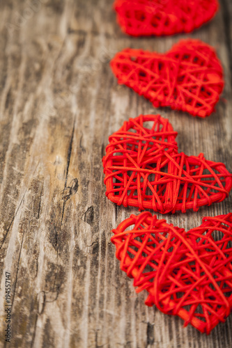 Red hearts on a wooden background.