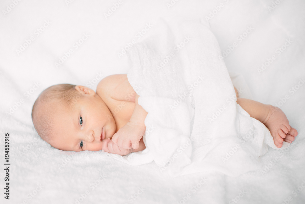 Cute newborn girl sleeping on furry cloth wearing white headband Cute newborn girl sleeping on furry cloth wearing white headband