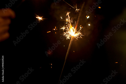 Burning sparkler  abstract blur background.