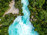Stunning aerial wide angle drone view of Huka Falls waterfall in Wairakei near Lake Taupo in New Zealand. The waterfall is part of the Waikato River and is a major tourist attraction.