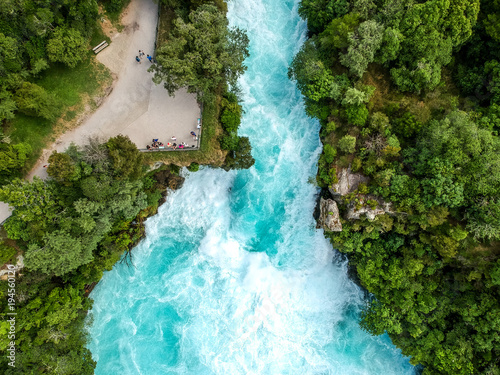 Stunning aerial wide angle drone view of Huka Falls waterfall in Wairakei near Lake Taupo in New Zealand. The waterfall is part of the Waikato River and is a major tourist attraction.
