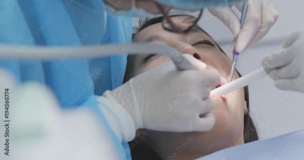 Woman checking on her teeth at dental clinic Woman checking on her teeth at dental clinic