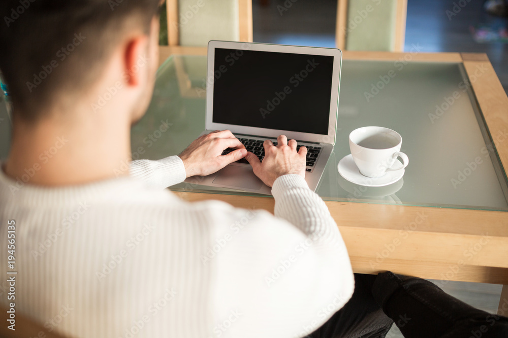 Man sitting at table at home working Man sitting at table at home working