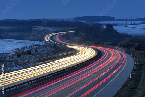 Traces of light on the A9 motorway, curvy road, twilight, winter, long-term exposure, near Schleiz, Thuringia, Germany, Europe