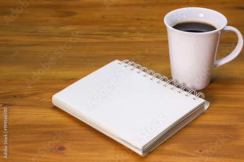 a coffee mug and a note book