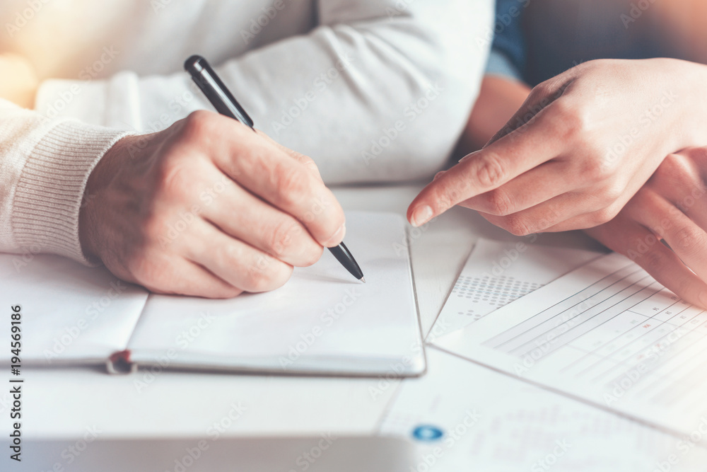 Write it down. Two partners sitting close to each other and making notes during discussion Write it down. Two partners sitting close to each other and making notes during discussion
