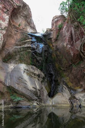 Waterfalls with large rock cliffs during the dry season.