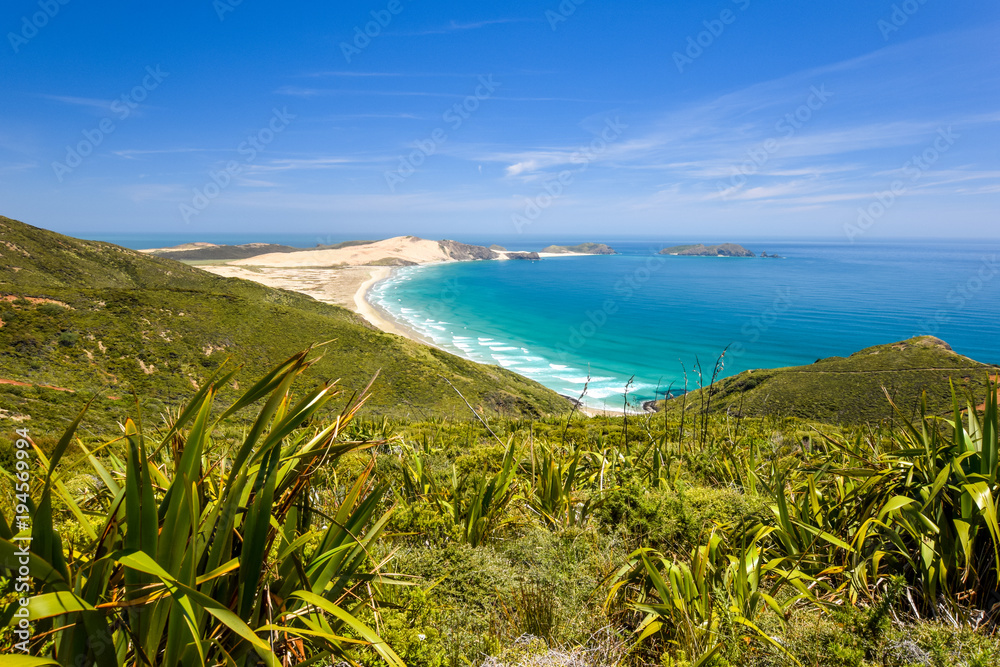 Stunning wide angle view of Cape Reinga, the northernmost point of the North Island of New Zealand. Cape Reinga with its beautiful beaches, coastline and the lighthouse is a famous tourist destination