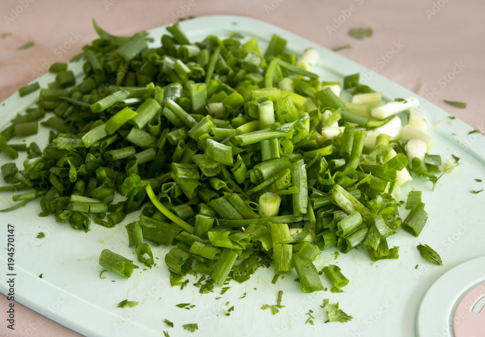 Sliced green onion on a cutting board Sliced green onion on a cutting board