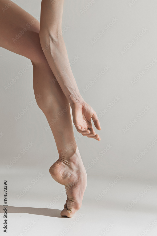 Fototapeta premium Close-up ballerina's legs on the white floor