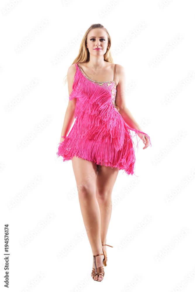 Front view of blonde woman in fringed dress walking and looking at camera. Full body length portrait isolated on white studio background. Front view of blonde woman in fringed dress walking and looking at camera. Full body length portrait isolated on white studio background.
