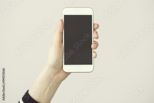 Holding white mobile phone