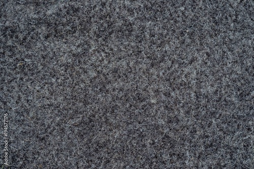 Classic sample of dark grey felt textile background.