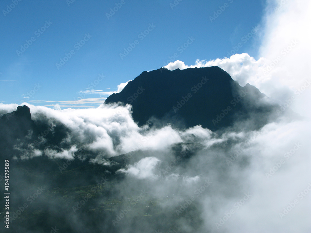 Saint Paul / La Reunion: View from the Maido peak over the Cirque de Mafate to the Piton des Neiges in the early morning when orographic clouds begin to cover the landscape