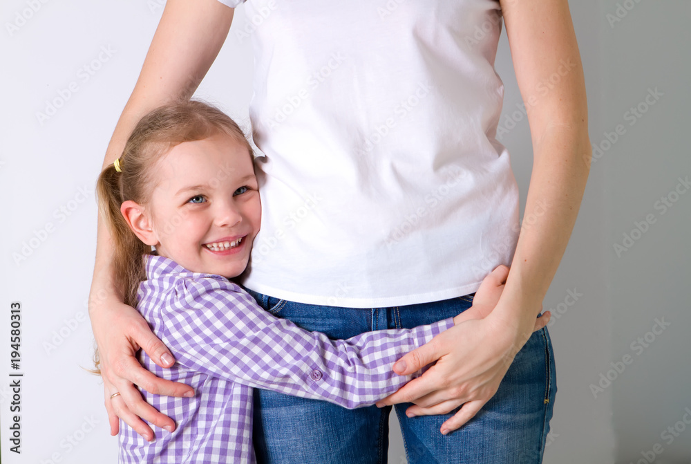 little child hugging his mother at home, isolated image, copy space. Family concept