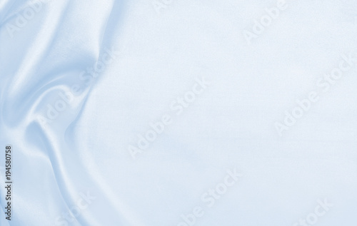 Smooth elegant blue silk or satin luxury cloth texture as abstract background. Luxurious background design