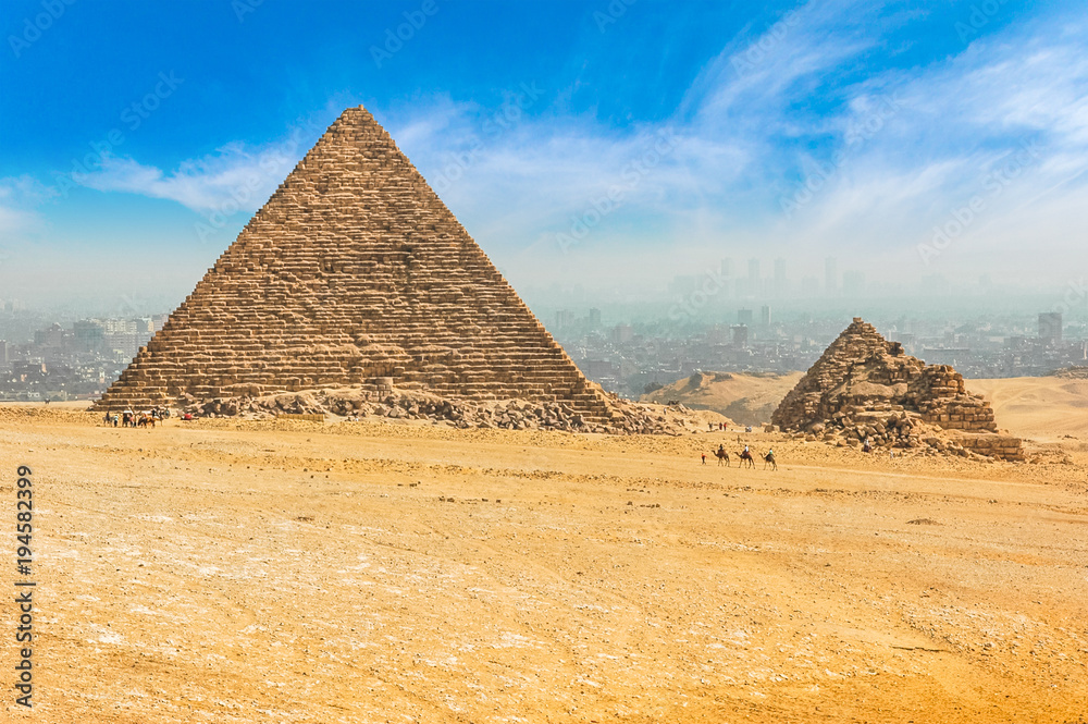 The Egyptian pyramids of Giza on the background of Cairo. Miracle of light. Architectural monument. The tombs of the pharaohs. Vacation holidays background wallpaper