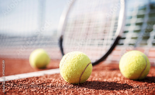 Tennis ball with racket on the tennis court. Sport, recreation concept © bobex73