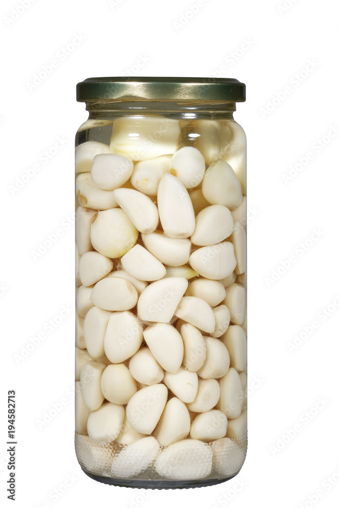 Seasoning pickled garlic in glass jar isolated on white background Seasoning pickled garlic in glass jar isolated on white background