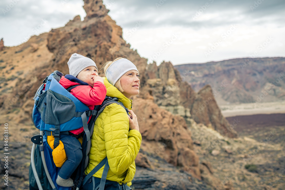 Fototapeta premium Family hike, mother with baby in backpack