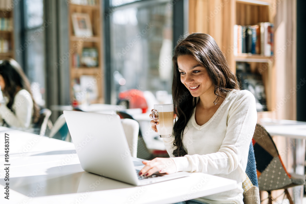 Beautiful brunette enjoying coffee and working