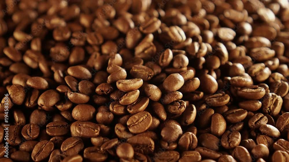Coffee close up. Coffee beans. Coffee beans. quality of grain roasted coffee to spill in the bag , slow motion Coffee close up. Coffee beans. Coffee beans. quality of grain roasted coffee to spill in the bag , slow motion