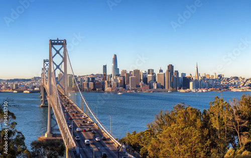 San Francisco skyline and Bay Bridge at sunrise, California photo