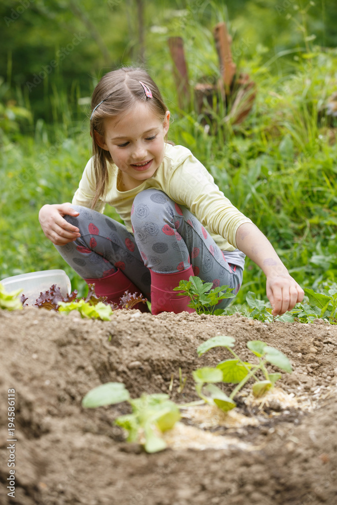 Little girl having fun in the garden, planting, gardening, helping her mother. Happy, natural childhood concept. Little girl having fun in the garden, planting, gardening, helping her mother. Happy, natural childhood concept.