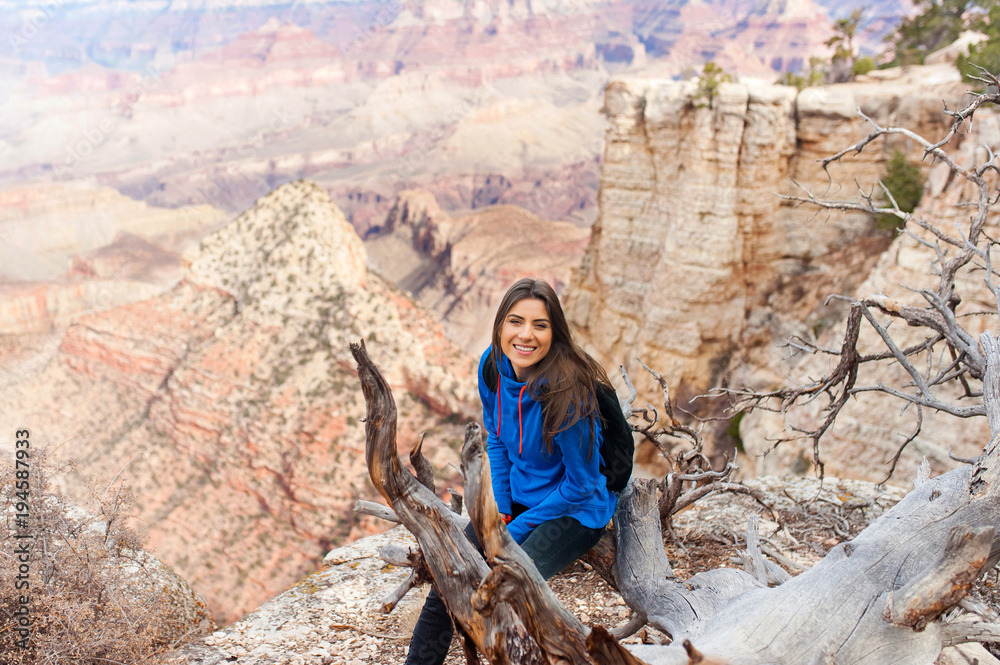 Travel hiking photo of young beautiful woman with backpack at Grand Canyon viewpoint, Arizona, USAm smiling at camera. Travel hiking photo of young beautiful woman with backpack at Grand Canyon viewpoint, Arizona, USAm smiling at camera.