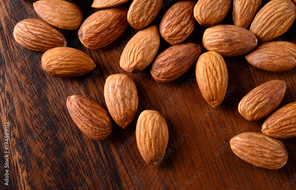 Almond. peeled nuts on textured wooden background. Organic food. Almond. peeled nuts on textured wooden background. Organic food.