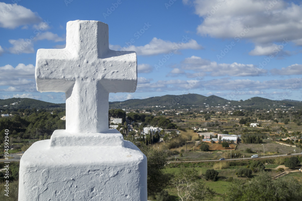 White cross and landscape in Santa Eularia des Riu, Ibiza, Spain. White cross and landscape in Santa Eularia des Riu, Ibiza, Spain.