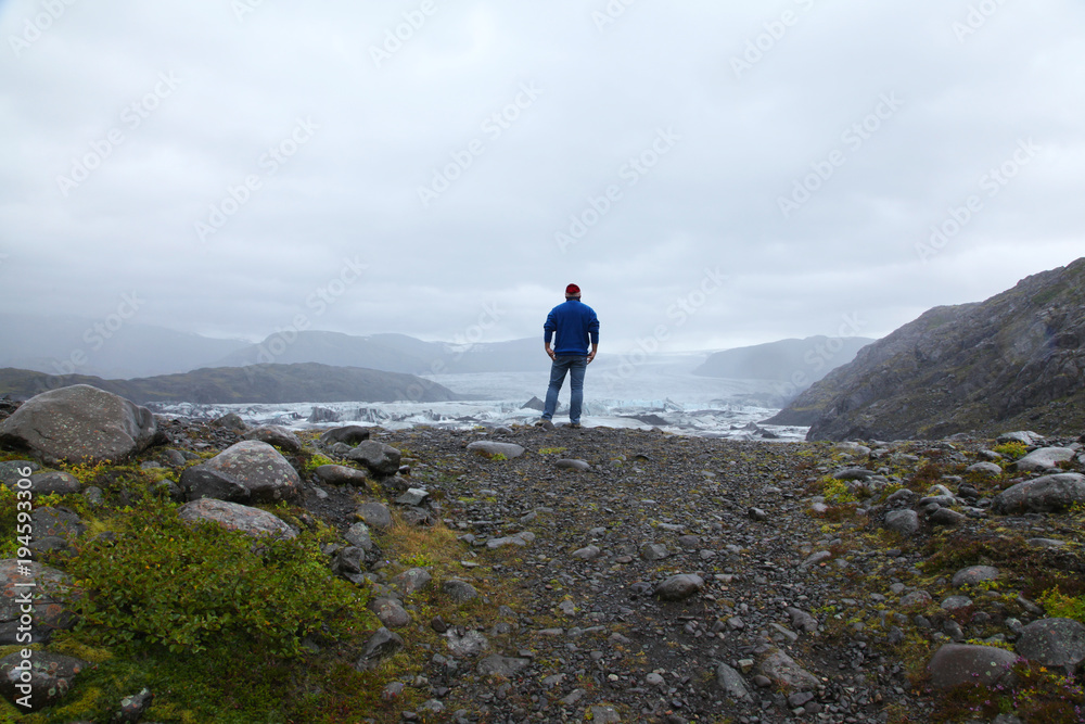 A lonely man looks and the Icelandic glacier