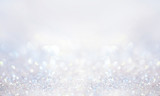 Glitter background in pastel delicate silver and white tones de-focused.