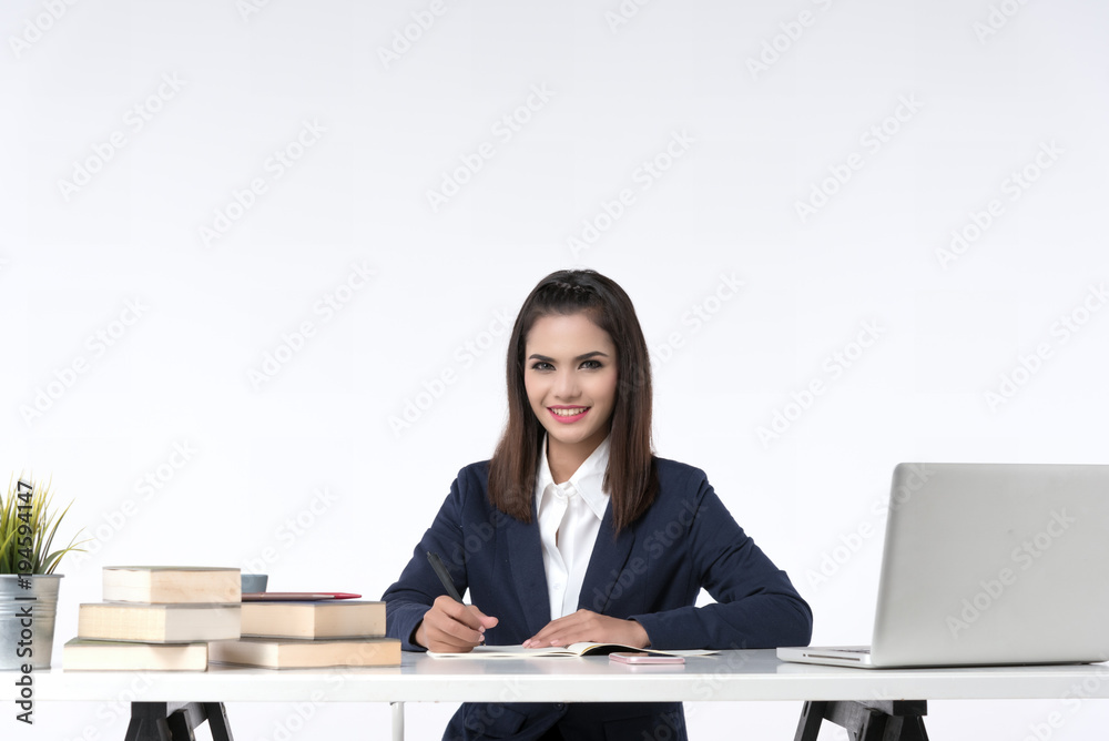 Beautiful office woman sit at table in office ,she work with laptop and use pen write report on notebook. Beautiful office woman sit at table in office ,she work with laptop and use pen write report on notebook.