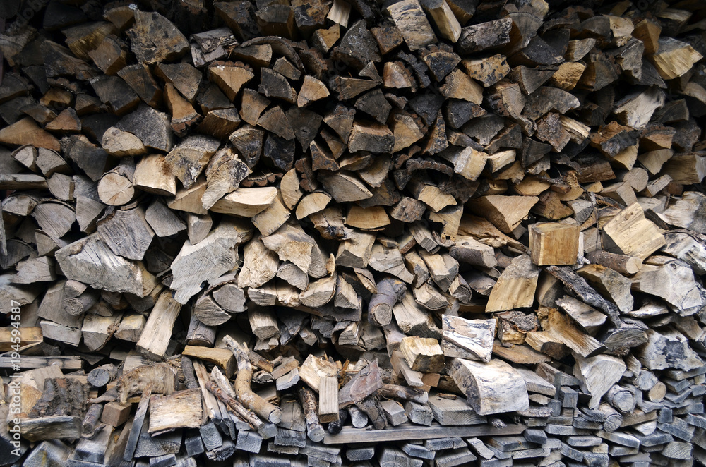 Detailed view to stacked and seasoned firewood for an open-hearth fireplace Detailed view to stacked and seasoned firewood for an open-hearth fireplace