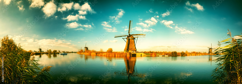 Traditional dutch windmills at sunny day. - obrazy, fototapety, plakaty 