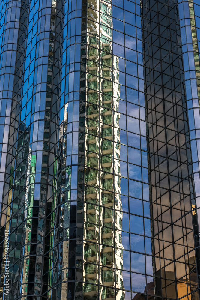 Fototapeta premium Reflections on glass buildings.