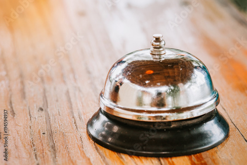 service bell - vintage filter on wood background.