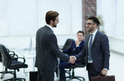 Two businessmen handshaking after striking grand deal